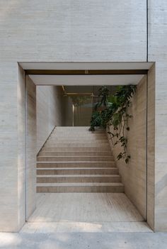 the stairs lead up to the second floor in this modern house with concrete walls and stone steps