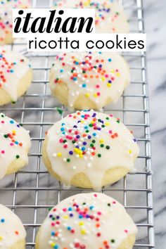 italian ricotta cookies with white icing and sprinkles on a cooling rack