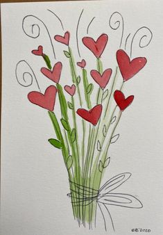 a card with red hearts in a vase