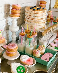 a table filled with lots of cakes and cupcakes