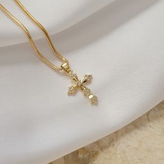 Crystal decor cross pendant necklace. Wear it on it's own or layer it.  Pendant details:  * Material: non tarnish gold filled, cubic zircon * Measurements: 0.9'H 0.6'W Chain: non tarnish gold filled Every item comes with vegan leather pouch for safe jewelry storing. Mark your order as a gift and we will add branded jewelry box at no extra cost GOLD FILLED Tarnish Resistant. Hypoallergenic. Long Lasting. Gold filled is affordable alternative to solid gold. Hypoallergenic - sensitive skin friendly. With proper care it will last for years. What is Gold Filled? "Gold-filled" is a USA industry standard that legally requires 1/20th, or 5% pure gold by weight.  It's a strictly regulated process that involves pressure bonding multiple layers of solid gold with extreme heat over a core of high qual Good Cross Necklace, God Jewellery, Cross Necklace For Women, Gold Cross Jewelry, Elegant Gold Cross Necklace With Chain, Elegant Gold Plated Cross Necklace, Catholic Cross Necklace Gold, Cross Necklace Gold, Gold Cross Necklace For Women