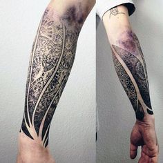 the arm is covered with intricate tattoos on it's sides, and there are two pictures