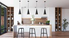 an open kitchen with three stools next to the counter and shelves on the wall