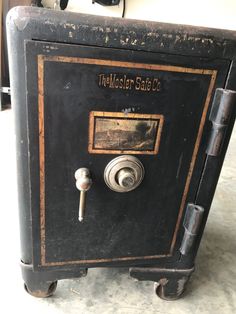 an old fashioned safe sits on the floor