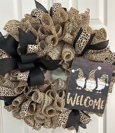 a leopard print wreath with a welcome sign