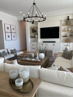 a living room filled with furniture and a flat screen tv mounted on the wall above it