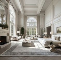 an elegant living room with white furniture and large windows