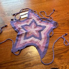 a purple crocheted star on a wooden table