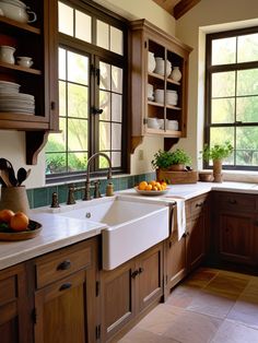 a kitchen filled with lots of wooden cabinets and counter top space next to a window