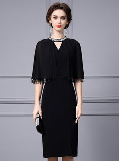 Honor the special day with this impeccably designed black mother of the bride dress! This dress captivates with its understated elegance and thoughtful details. The soft, floaty sleeves trimmed with playful tassels add a contemporary twist to the classic A-line cut, while the cinched waist creates a flattering silhouette. Embellished with a subtle yet striking jeweled neckpiece, this dress becomes the epitome of chic sophistication. The smooth fabric promises ease of wear from the ceremony to the reception, ensuring the wearer feels as fabulous as they look. Perfect for an evening of celebration, this dress is a testament to the mother's role: integral, distinguished, and dignified. Elegant Mother Of The Bride Dress With Cape Sleeves, Formal Mother Of The Bride Dress With Cape Sleeves, Fitted Cape Sleeve Dress For Mother Of The Bride, Mother Of The Bride Evening Dress With Cape Sleeves, Evening Mother Of The Bride Dress With Cape Sleeves, Black Fitted Dress For Mother Of The Bride, Elegant Black Mother Of The Bride Evening Dress, Black Evening Mother Of The Bride Dress, Elegant Black Evening Dress For Dinner