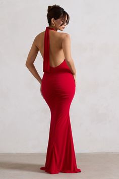 a woman in a red dress with her back to the camera