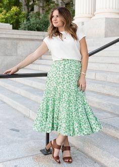 Mikayla is 5'5" and wearing a size small - Runs TTS - Elastic waistband for a comfortable fit - Beautiful true green floral print on a cream background - Tiered skirt for extra flow - Not see-through - Available in two colorways Product Measurements*Measurements are taken from side seam to side seamwhile laying flat. Small: Length: 34" Waist: 12" Medium: Length: 34" Waist: 13" Large: Length: 34.5" Waist: 14" Material and CareSelf: 100% Polyester Hand Wash in Cold Water Separately. Do Not Bleach. Spring Green Flowy Skirt, Spring Green Skirt With Elastic Waistband, Green Skirt With Elastic Waistband For Spring, Green Flared Skirt With Floral Print, Green Floral Print Flowy Skirt, Green Flowy Skirt For Spring, Green Skirt For Spring Garden Party, Green Tiered Skirt For Day Out, Green Bottoms For Summer Garden Party