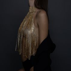 Turn heads and make a statement with our stunning Gold Crystal Chain Halter Top. This exquisite piece of evening wear is designed to dazzle and impress, perfect for special occasions, glamorous nights out, or any event where you want to shine. Premium Quality: Crafted from high-quality materials, this halter top features intricately linked gold chains adorned with sparkling crystals. Unique Design: The backless design with delicate chain details adds a touch of elegance and sophistication, ensur Glamorous Silver Body Jewelry For Party, Elegant Embellished Body Jewelry For Parties, Glamorous Party Jewelry With Chain Detail, Glamorous Party Jewelry With Chain, Glamorous Silver Body Chain For Party, Glamorous Embellished Party Jewelry, Glamorous Embellished Gold Jewelry, Gold Body Chain For Parties, Glamorous Gold Embellished Jewelry