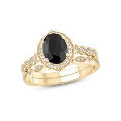 a black and white diamond engagement ring in yellow gold