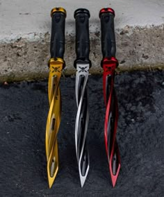 three different colored umbrellas sitting next to each other