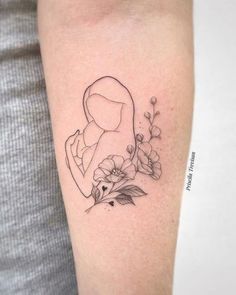 a woman's arm with flowers and a tattoo on the left side of it