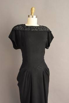 "Vintage 1950s jet black cocktail party dress with wonderful glass beading throughout. This vintage dress features a flattering fitted bodice with bust darts, nipped waist, and a lovely draped skirt. There is a back metal zipper for closure. ✂------ M E A S U R E M E N T S ------- Best Fit: Medium Bust: 37.5\" Waist: 29.5/30\" Hips: 42\" Shoulders: undefined Sleeves: 4.5\" Total Length: 49.5\" Material: rayon Condition: Excellent vintage condition. Ready to wear. ☆ Layaway is available for this Black Fitted 1950s Style Dress, Fitted Black Dress In 1950s Style, Fitted Black 1950s Dress, Fitted Black Dress 1950s Style, 1950s Short Sleeve Evening Dresses, 1950s Fitted Black Dress, Black Cocktail Party, Black Cocktail Party Dress, Nostalgic Images