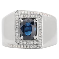 a ring with a blue stone surrounded by white diamonds