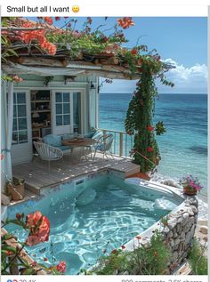 an outdoor hot tub next to the ocean with flowers growing on it's roof