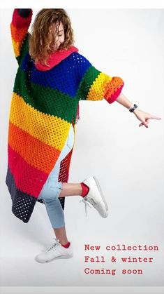 a woman in a colorful sweater is dancing