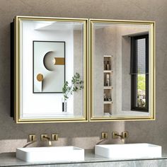 a bathroom with two sinks and mirrors on the wall