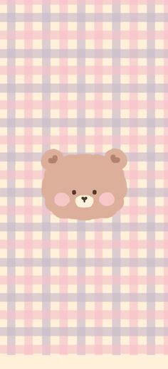 a brown teddy bear sitting on top of a pink and white checkered wall