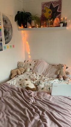 there is a bed with pink sheets and teddy bears on it