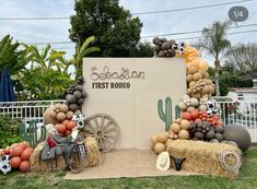 an outdoor display with balloons and decorations for a first rodeo birthday or baby's 1st birthday