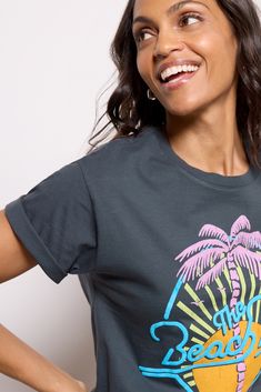 Finished with a neon sun and palm tree graphic, this Beach Boys tee by Daydreamer features a relaxed crewneck silhouette, short sleeves, and soft cotton fabric for a vintage feel. Style with shorts or cargo pants for a sunny day look. Palm Tree Graphic, Beach Boys, Tree Graphic, Brand Style Guide, California Dreaming, Fashion 101, Boy Tees, Spring Trends, Woman Beach