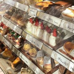 a display case filled with lots of different types of cakes and pastries in it