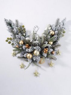 silver and gold christmas decorations on a white background with snowflakes, pine cones and evergreen branches