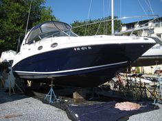 a blue and white boat sitting on top of a trailer