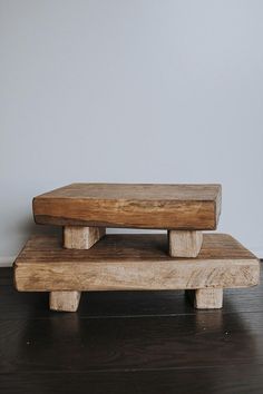 a wooden bench sitting on top of a hard wood floor