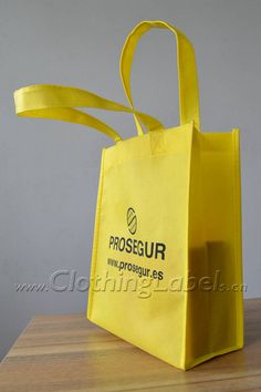 a yellow bag sitting on top of a wooden table