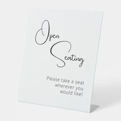 an open seating sign with the words please take a seat wherever you would like