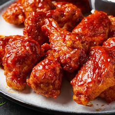 chicken wings covered in bbq sauce on a plate