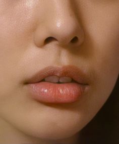 a close up of a woman's face with her eyes closed and lips slightly open