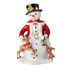 a christmas ornament with a snowman and two deer on it's side