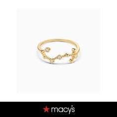 a gold ring with stars on it and the words macy's written in white letters