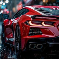 a red sports car parked in the rain