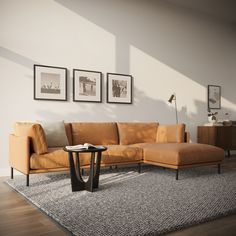 a living room with a couch, table and pictures on the wall