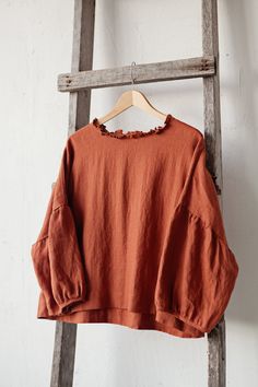 Tunic is made from 100% soft and washed linen. Match it with our skirts! Details: - Composition: 100% Oeko-Tex certified linen - Colour: rust - Ruffle neckline - Dropped shoulders - Size: One size/fits all - Medium weight linen - Linen care: machine wash gentle; tumble dry low, ironing optional - The price is for one tunic, other pictured items are not included Measurements: Length from shoulder down: 55 cm (21,66 in) Chest width: 140 cm (55,1 in) Sleeve length (from collar): 60 cm (23,6 in) Bot Relaxed Fit Blouse With Natural Dye For Spring, Linen Lagenlook Blouse For Fall, Fall Linen Tops With Natural Dye, Oversized Bohemian Linen Tops, Spring Long Sleeve Tops With Natural Dye, Fall Lagenlook Linen Tops, Oversized Long Sleeve Ramie Tops, Fall Linen Tunic Blouse, Rust Blouse