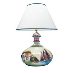 a lamp that is sitting on top of a white table cloth with a blue border around it