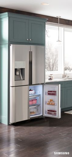 an open refrigerator in a kitchen next to a window