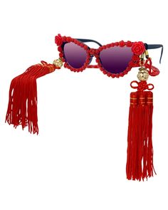 These elegant, statement-making sunglasses will instantly make you the life of the party! Beautifully intricate rose blossoms completely encircle the black cat eye frames. A marbled red acrylic neck chain dangles with ease, and can easily be converted into a fabulous mask chain! These sunnies wouldn't be complete without the removable geisha inspired silk tassels that hang effortlessly at each temple. Each tassel is embellished with shiny crystal rhinestone encrusted gold disco balls. You are su Making Sunglasses, Novelty Sunglasses, Black Cat Eye, Silk Tassels, The Black Cat, Mask Chain, Black Cat Eyes, Eye Frames, Disco Balls