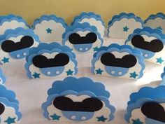 a table topped with lots of blue and white cupcakes