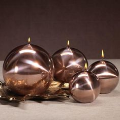 three candles sitting on top of a table next to each other