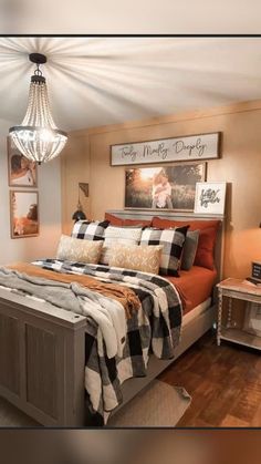 a bedroom with a bed, nightstands and pictures hanging on the wall above it