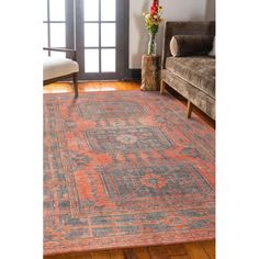 an orange and blue rug in a living room