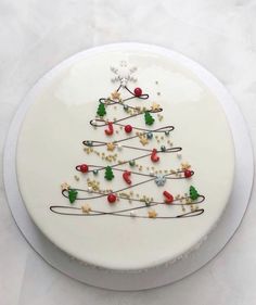 a white plate with a decorated christmas tree on it